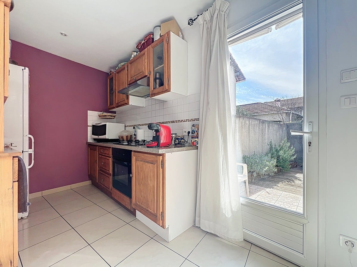 Cuisine aménagée avec meubles et équipements intégrés. Espace fonctionnel avec plan de travail et rangements dans une maison T3 située à Avignon secteur Saint-Geniest.